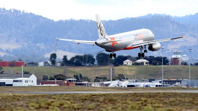 A Jetstar plane landing at Hobart Airport.