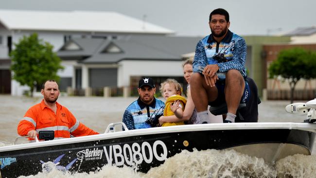 Antonio Winterstein and John Asiata help get residents out of the floodwaters.