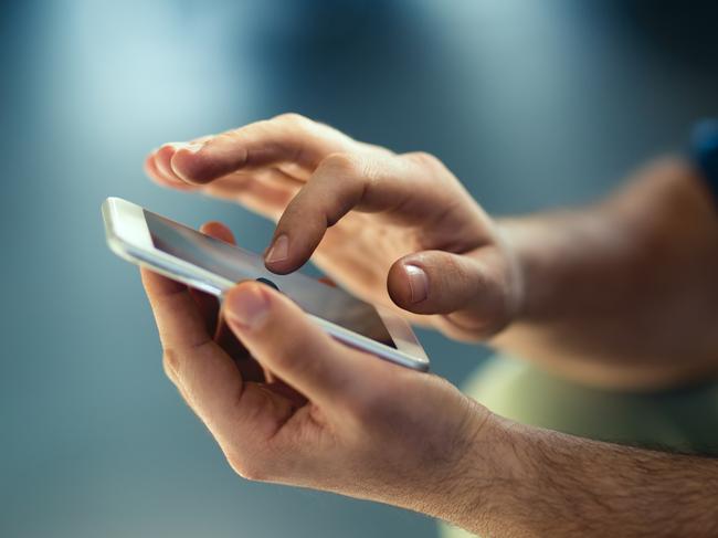 Generic Male hands typing on smartphone. Picture: Istock