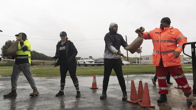 SES volunteers, some of whom have worked overnight, fill sandbags for local residents at the Penrith branch of the SES on Saturday morning. Picture: Brook Mitchell/Getty