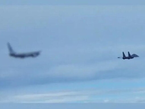 The footage showed a PLA jet (R firing flares and chaff at the RAAF plane (L).