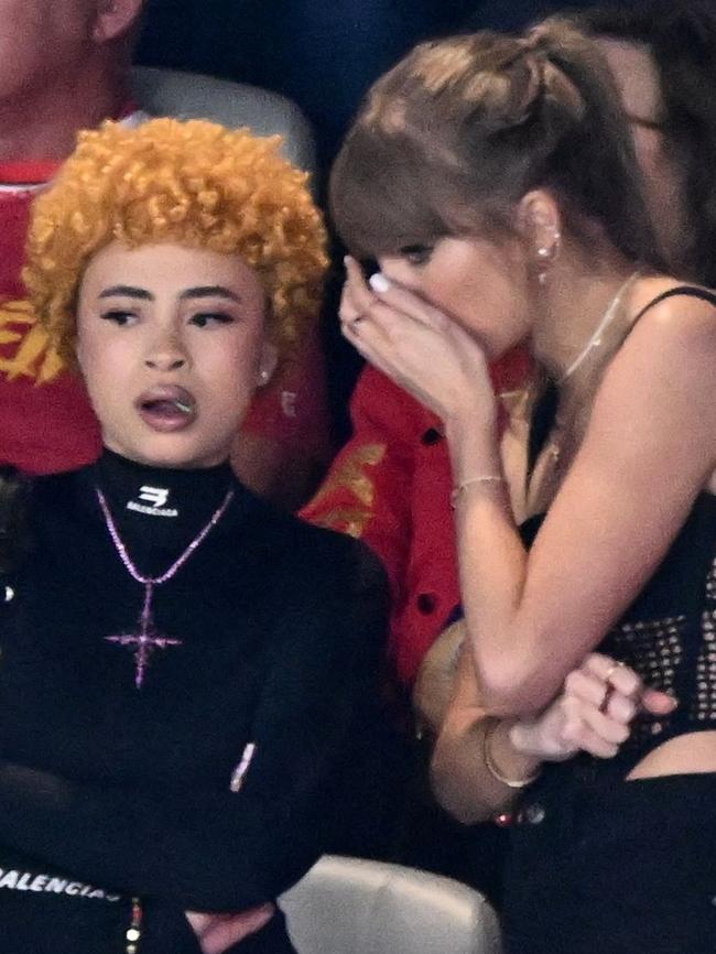 The singer whispered in her friend’s ear during the game. Picture: Patrick T. Fallon/AFP