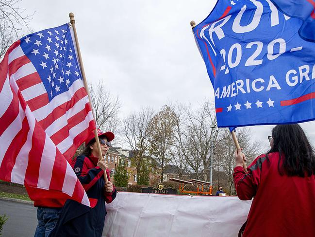 Supporters of Donald Trump wait outside his Virginia golf club to catch a glimpse of him. Picture: Getty Images/AFP