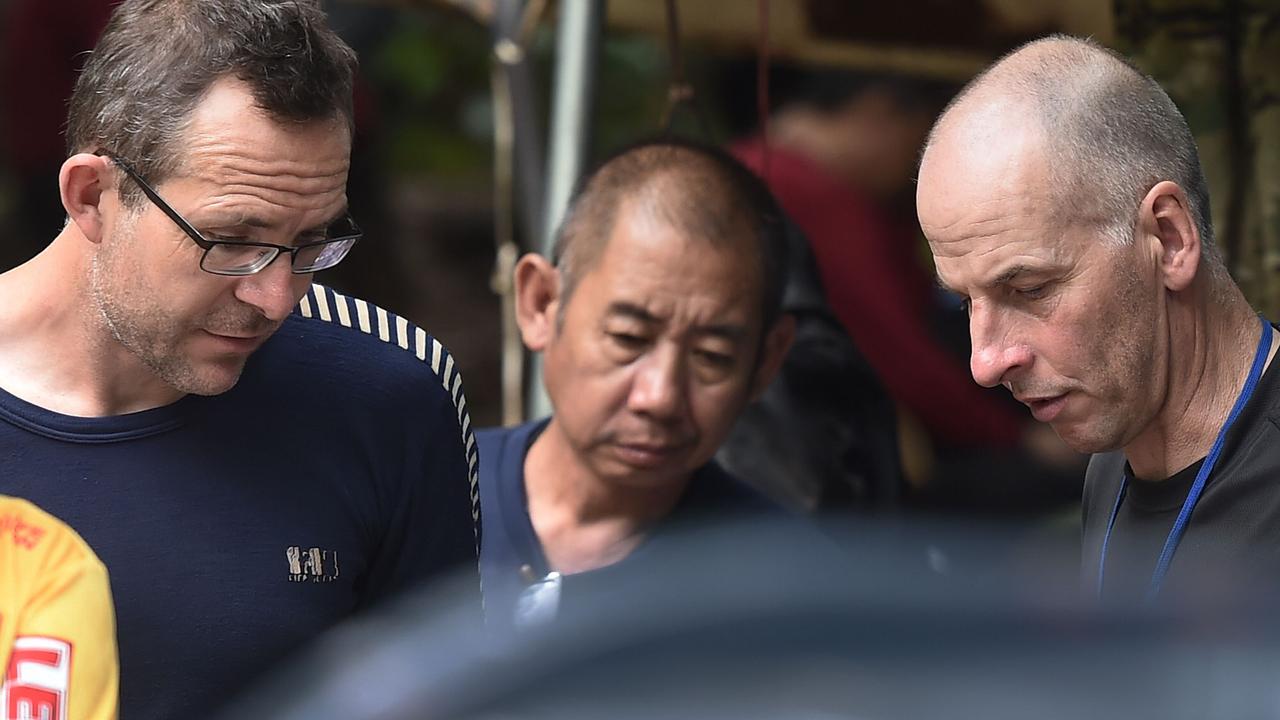 British divers John Volanthen and Richard Stanton with a Thai rescuer after finding the Wild Boars alive in the cave. Picture: Lillian Suwanrumpha