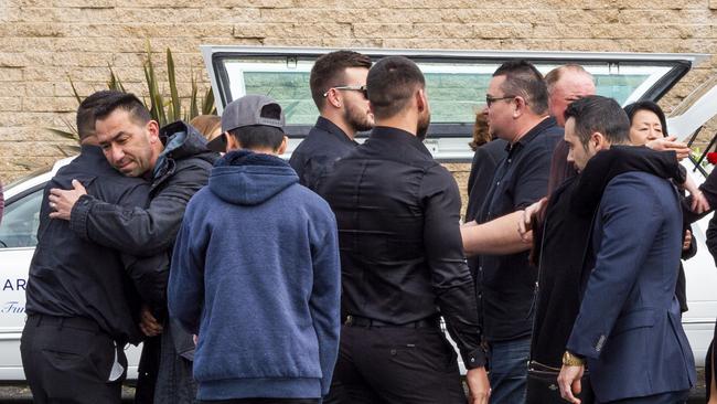 Mourners are seen embracing after the service. Picture: NCA NewsWire / Monique Harmer