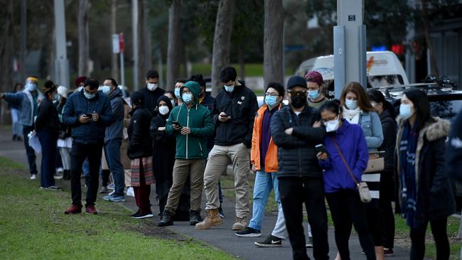 Crowds of people wearing face masks defy wait in line to receive a Covid-19 vaccination at the NSW vaccination hub in Sydney. Picture: NCA NewsWire/Bianca De Marchi