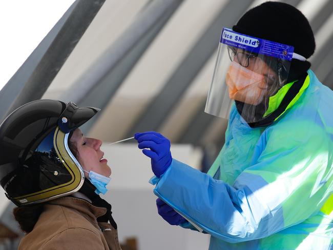 SYDNEY, AUSTRALIA - NewsWire Photos JULY 05, 2021: A nurse performs a covid test for a motor cycle rider as they attend the Bondi Beach Covid-19 Drive thru testing clinic as we enter week 2 of lockdown in Sydney Australia. Picture: NCA NewsWire / Gaye Gerard