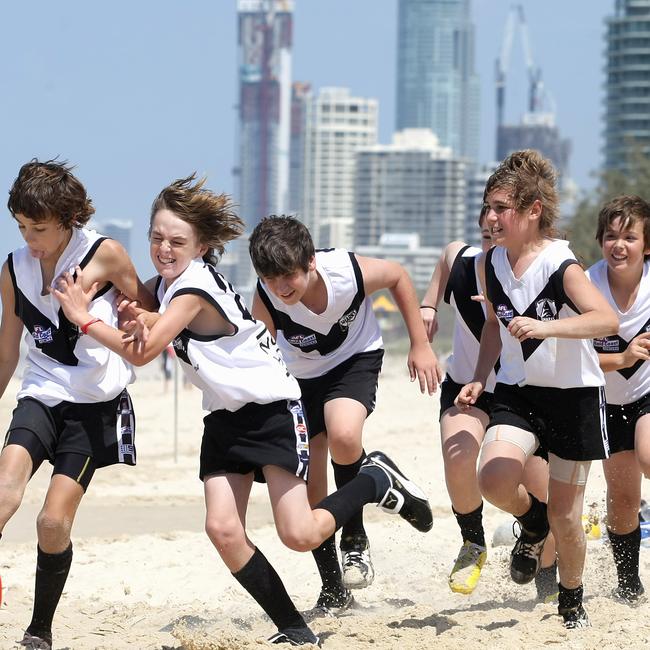 Members of the Southport Sharks u/14's captain Zane Baker, 13 (with ball ) on the beach of the Gold Coast Pics Tim Marsden