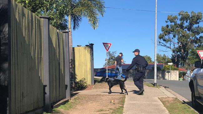 Police raid a house in Arana Hills. Photo: Kara Sonter