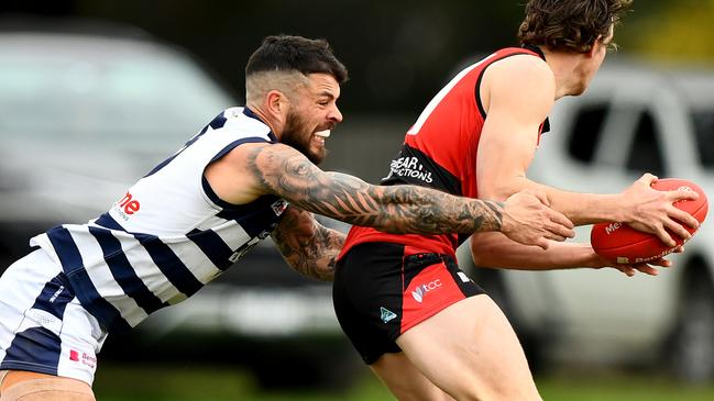 Romsey’s Jaxson Kinnear is tackled by Hamish Govan of Macedon. Picture: Josh Chadwick