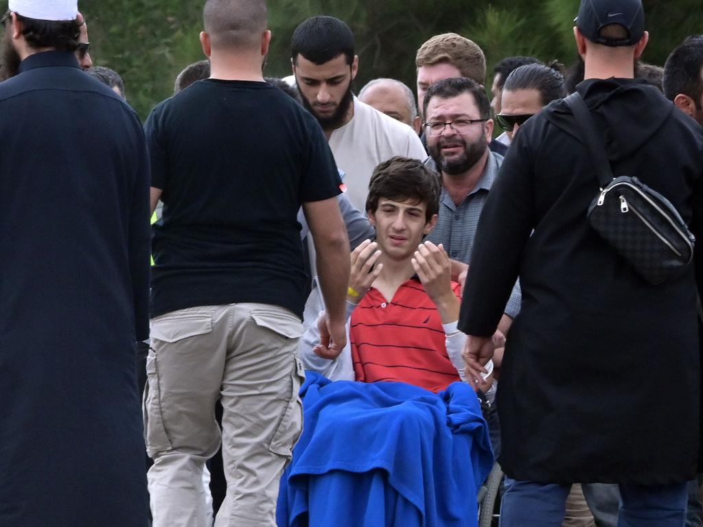 Zaid Mustafa, in a wheelchair after Friday’s attack, during the funeral of his slain father Khalid Mustafa and brother Hamza Mustafa. Picture: Anthony Wallace/AFP