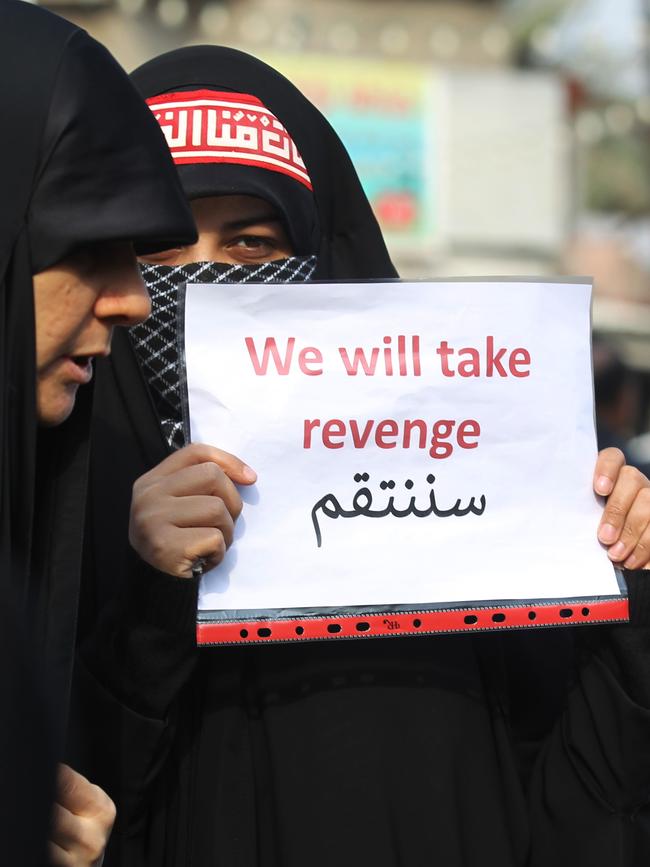 An Iraqi woman holds a placard during the funeral of Iranian military commander Qasem Soleimani. Picture: AFP