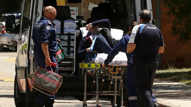 A second girl is taken from the school in an ambulance. Picture: Justin Sanson