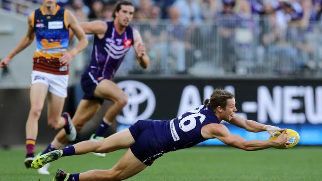 PERTH, AUSTRALIA - MAY 26: Ed Langdon of the Dockers marks the ball during the round 10 AFL match between the Fremantle Dockers and the Brisbane Lions at Optus Stadium on May 26, 2019 in Perth, Australia. (Photo by Will Russell/AFL Photos/Getty Images)