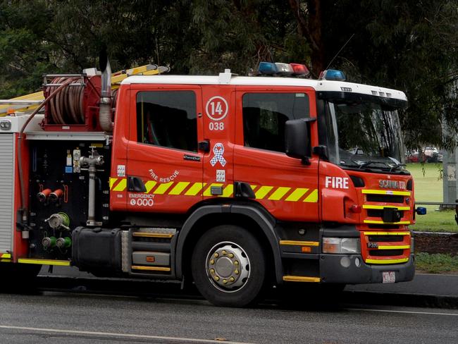 MELBOURNE, AUSTRALIA - NewsWire Photos JULY 7: Fire crews parked along Mount Alexander Road behind the Flemington public housing estate after it was put into lockdown on Saturday. Picture: NCA NewsWire / Andrew Henshaw