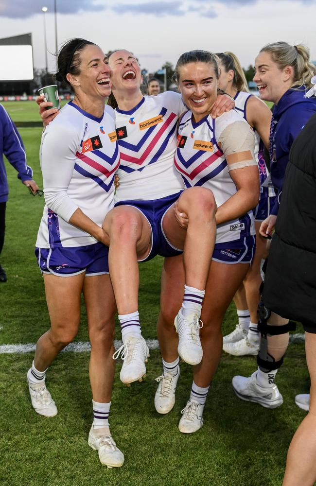 Gabrielle Newton is carried off by Angelique Stannett and Orlagh Lally after Fremantle’s win. Picture: Mark Brake/Getty Images.