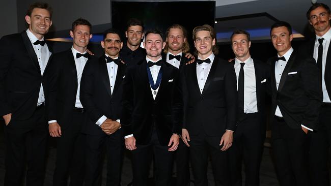 Lachie Neale of the Lions poses with teammates after being awarded the Brownlow Medal (Photo by Albert Perez/AFL Photos via Getty Images)