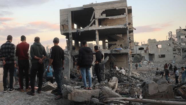 Palestinians inspect the damage at the site of an Israeli air strike on the Bureij refugee camp in the central Gaza Strip. Picture: Eyad Baba/AFP