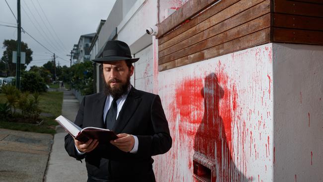 Rabbi Shmueli Feldman prays outside the former home of Alex Ryvchin. Picture: Max Mason-Hubers/The Australian