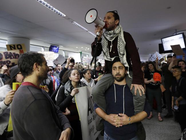 Protesters rally outside the arrivals terminal at San Francisco International Airport to denounce President Donald Trump's executive order. Picture: AP Photo/Marcio Jose Sanchez