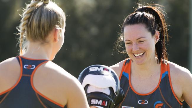 Giants netballers Jamie-Lee Price takes the hits from teammate Sam Poolman during a boxing session.