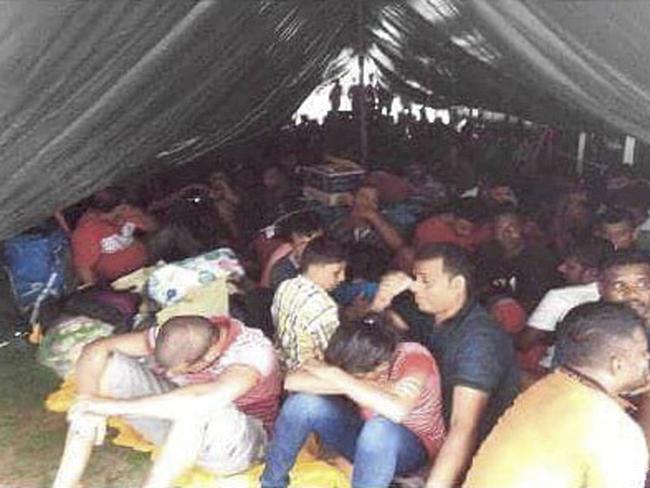 This May 5, 2018, photo, released by the Royal Malaysian Police, shows illegal migrants on a rusty tanker near kota tinggi in Johor state, Malaysia. Malaysian police have intercepted a tanker with 131 Sri Lankans believed bound for Australia and New Zealand, smashing a large human smuggling ring that has been operating for over a year. (Royal Malaysia Police via AP)