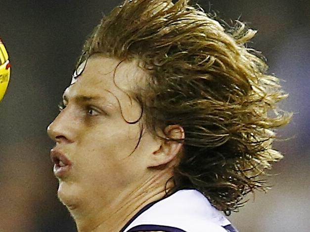 AFL Round 11: Western Bulldogs v Fremantle at Etihad Stadium. Nat Fyfe tries to take possession with Mitch Wallis close by. Pic: Michael Klein. Saturday May 31, 2014.