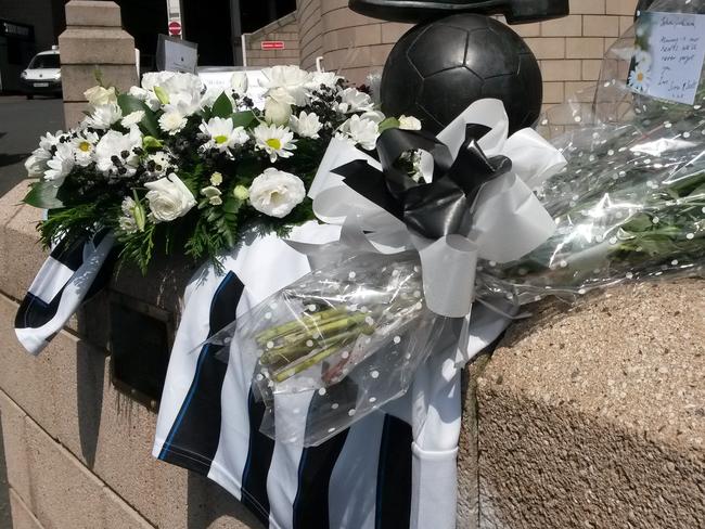 Flowers and football shirts are laid around the Sir Bobby Robson statue outside St James Park the home of Newcastle United soccer team in Newcastle England Friday July 18, 2014, after two fans of the club died on board flight MH17 which was shot down over the Ukraine on Thursday. John Alder, in his 60s, and Liam Sweeney, 28, were travelling to New Zealand to watch Newcastle play in a pre-season tour. (AP Photo/Tom White/PA) UNITED KINGDOM OUT NO SALES NO ARCHIVE