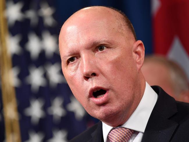 (FILES) In this file photo taken on March 6, 2020 Australia's Home Affairs Minister Peter Dutton announces measures against online sexual exploitation during a press conference at the Department of Justice in Washington, DC. - Some celebrities around the world are affected by the novel coronavirus. Australian Interior Minister Peter Dutton is hospitalized after being tested positive to the Covid-19. (Photo by MANDEL NGAN / AFP)