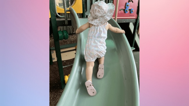 My daughter playing on the slide while the little girl was using the potty.