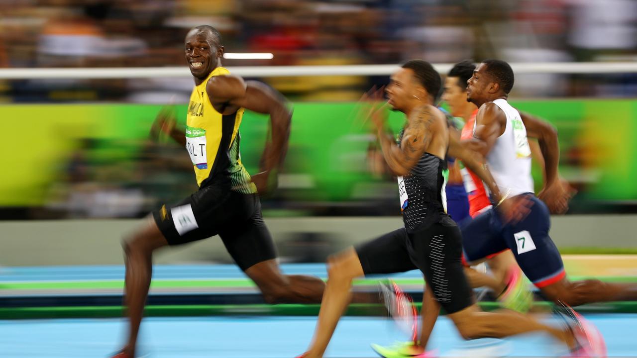 Olympic glory: Usain Bolt of Jamaica looks at Andre De Grasse of Canada as they compete in the 2016 Rio Olympics, Men's 100m Semifinals. REUTERS/Kai Pfaffenbach