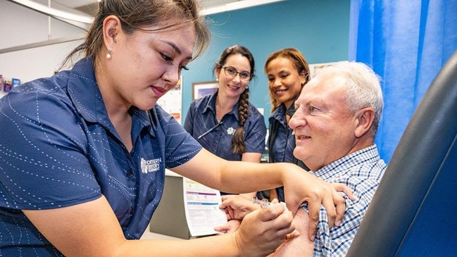 Registered Nurse Kim Dela Cruz gives the Minister for Health Steve Edgington his flu shot at the Casuarina Community Care Centre. Picture: NT Health