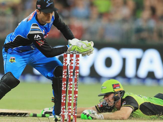 Ben Rohrer of Thunder slides into the crease as Striker Alex Carey knocks off the bails during the Big Bash League match. Picture: Mark Evans/Getty