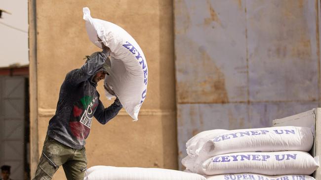 A worker piles up bags of flour inside a warehouse in Iraq's southern port city of Basra. Russia's invasion of Ukraine could mean less bread on the table in Egypt, Lebanon, Yemen and elsewhere in the Arab world where millions already struggle to survive.