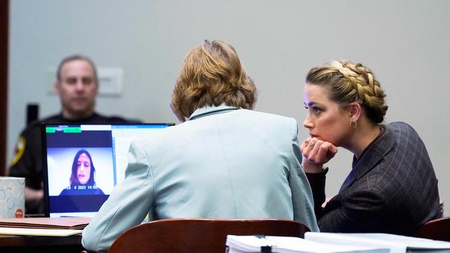 Heard and her attorney, Elaine Bredehoft, listen to Erin Falati, also known as Erin Boerum, a former nurse of Amber Heard, as she testifies. Picture: AFP