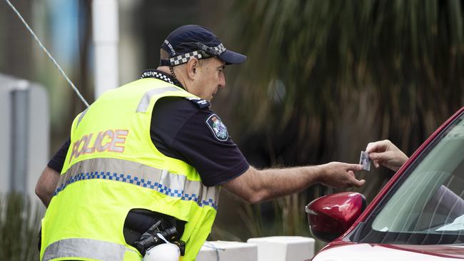 A police officer checking a motorist’s details at the border. Picture: Nigel Hallett.