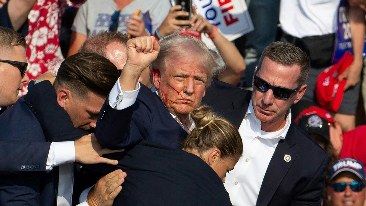 Republican candidate Donald Trump is seen with blood on his face following the assassination attempt. Picture: Rebecca Droke/AFP