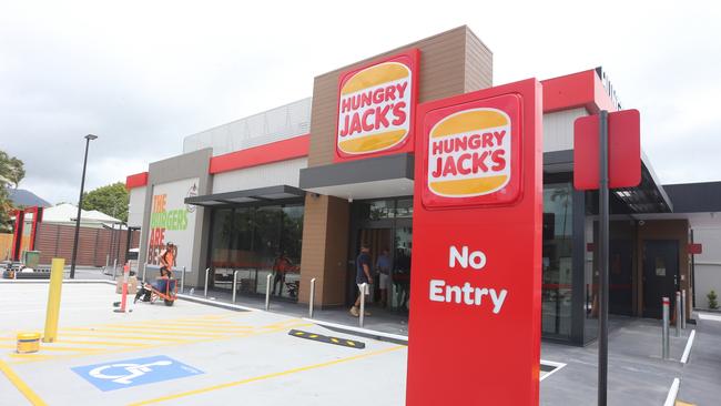 Workers adding finishing touches to the new Cairns North Hungry Jacks outlet on Thursday. Picture: Peter Carruthers