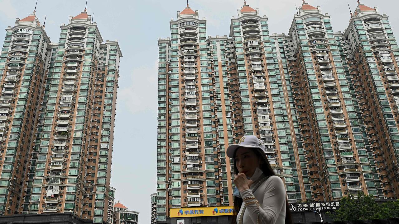 A woman walking past a housing complex by Chinese property developer Evergrande in Guangzhou, China's southern Guangdong province. Picture: Noel Celis / AFP