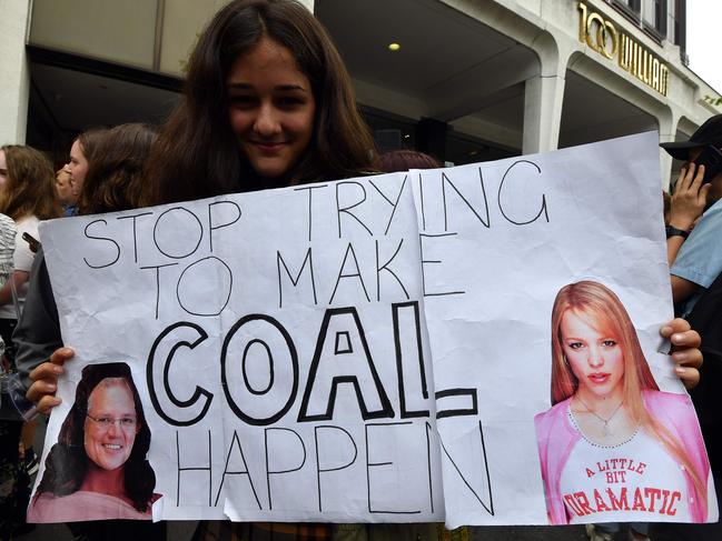 A student holds up a placard during a rally calling for action on climate change in front of the Liberal Party headquarters in Sydney on November 29, 2019. - Protesters in smoke-covered Sydney kicked off a fresh round of global protests against climate change on November 29, with activists and school kids picketing the headquarters of bushfire-ravaged Australia's ruling party. (Photo by Saeed KHAN / AFP)