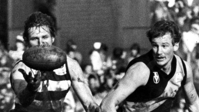 Jack Hawkins (left) vies with Michael Roach for possession during a VFL game in 1981.