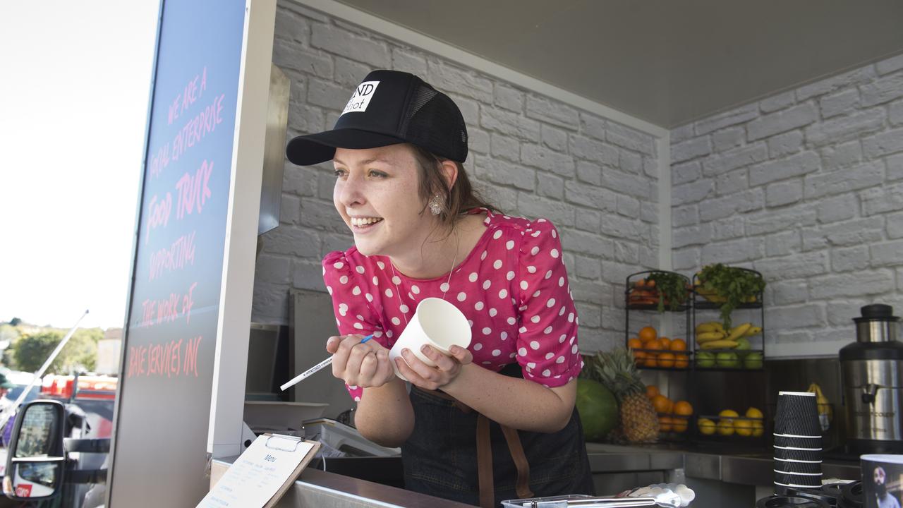 Toowoomba Clubhouse trainer May Volp takes a coffee order for the 2nd Shot food truck run by BASE Services.