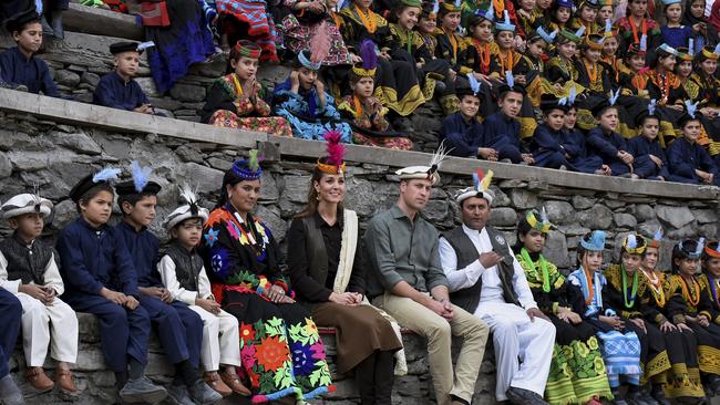 Prince William, centre, and his wife Kate sit with members of the Kalash community for a traditional dance during their visit to Bumburate Valley, an area of Pakistan's northern Chitral district.