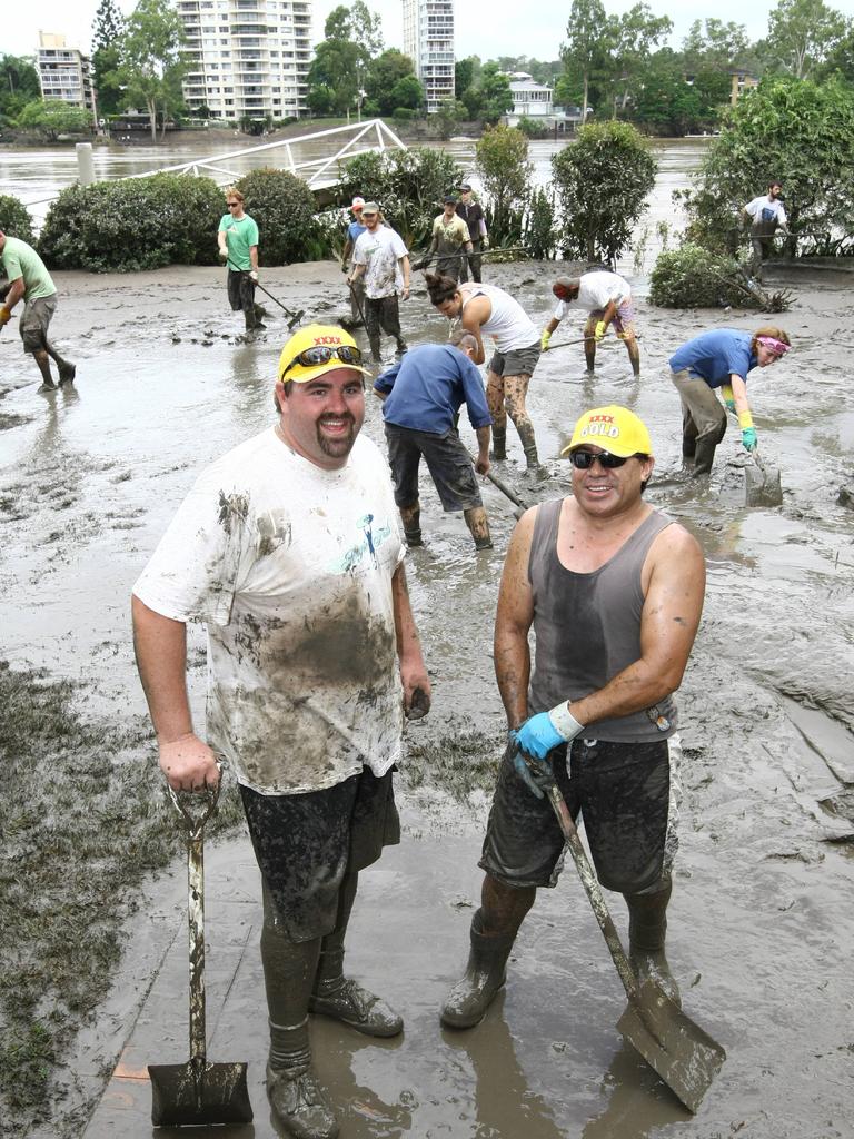 Mark Hobbs and Henry Poloai take a break in the Brisbane flood clean-up.