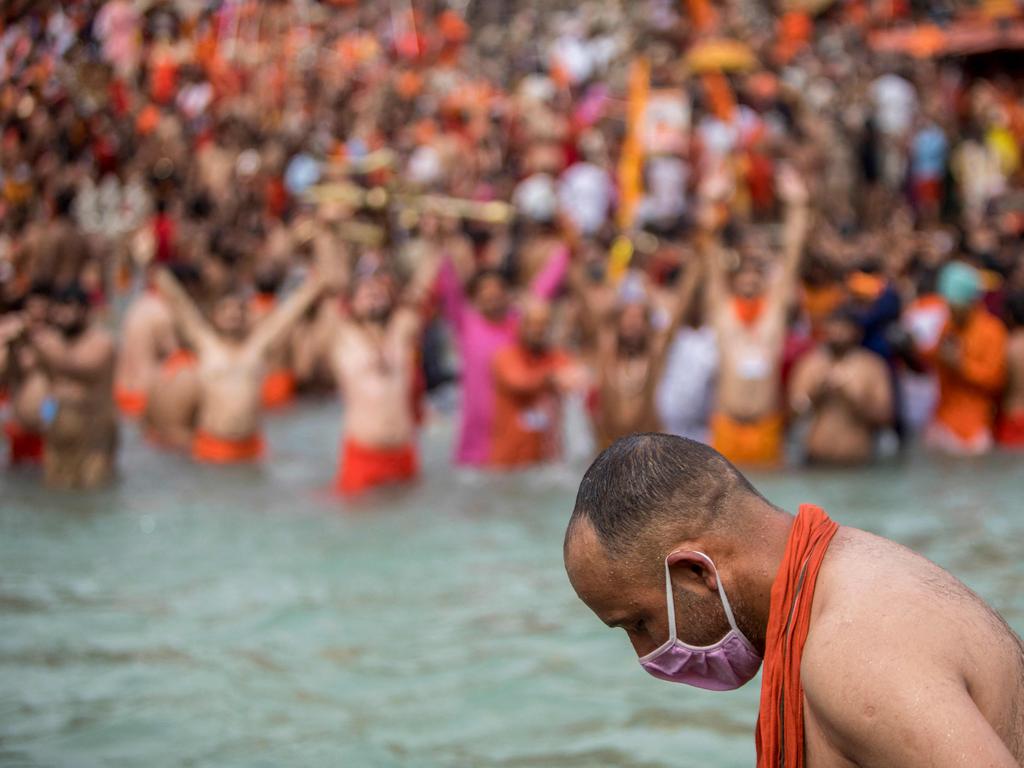 A Sadhu wearing a mask takes a holy dip in the Ganges river during the ongoing religious Kumbh Mela festival. Picture: Xavier Galiana/AFP