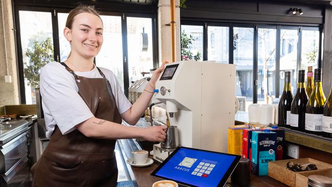 Maya Shepherd, 19, with robot milk steamer at Abacus in South Yarra. Hundreds of Melbourne cafes are replacing baristas with futuristic automated milk steamers and are said to save cafes Ãthousands a weekÃ . Picture: Jason Edwards