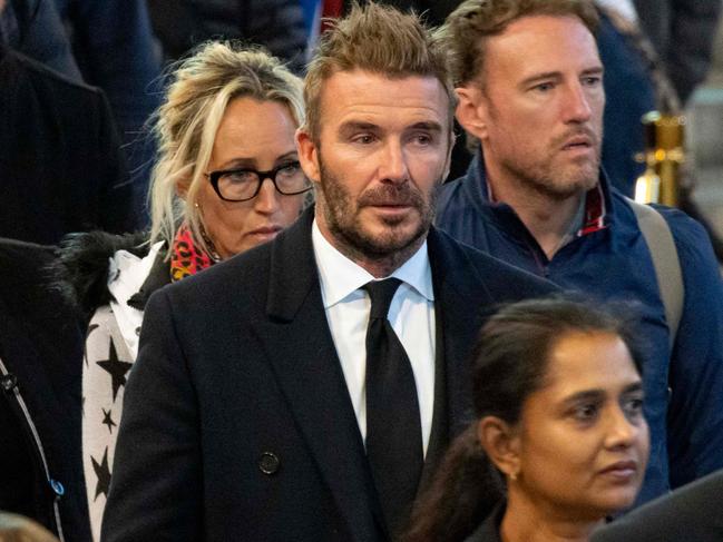 A handout photograph released by the UK Parliament shows former England football captain David Beckham waiting to pay his respects as he passes the coffin of Queen Elizabeth II, Lying in State inside Westminster Hall, at the Palace of Westminster in London on September 16, 2022. - Queen Elizabeth II will lie in state in Westminster Hall inside the Palace of Westminster, until 0530 GMT on September 19, a few hours before her funeral, with huge queues expected to file past her coffin to pay their respects. (Photo by ROGER HARRIS / UK PARLIAMENT / AFP) / RESTRICTED TO EDITORIAL USE - NO USE FOR ENTERTAINMENT, SATIRICAL, ADVERTISING PURPOSES - MANDATORY CREDIT " AFP PHOTO / ROGER HARRIS /UK Parliament"