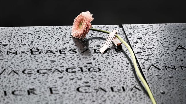 Flowers are placed over names at the September 11th Memoria in New York City.