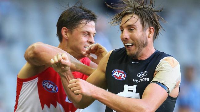 MELBOURNE, AUSTRALIA - MARCH 11: Callum Sinclair of the Swans and Dale Thomas of the Blues bump each other during the NAB Challenge AFL match between the Carlton Blues and the Sydney Swans at Etihad Stadium on March 11, 2016 in Melbourne, Australia. (Photo by Quinn Rooney/Getty Images)