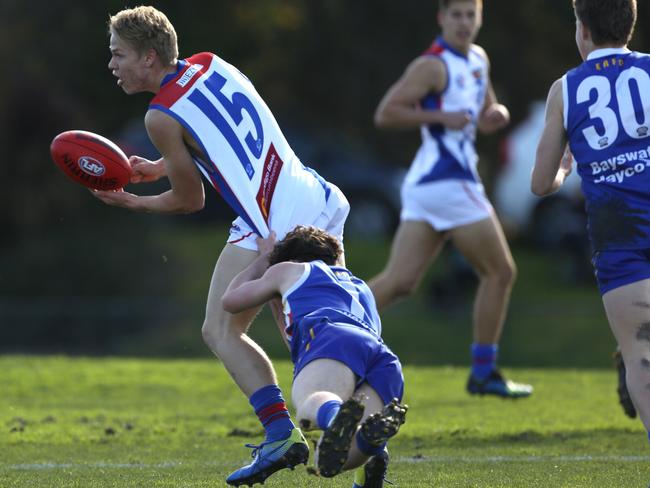 Kaden Schreiber dishes off a handball during a NAB League game. Picture: Stuart Milligan